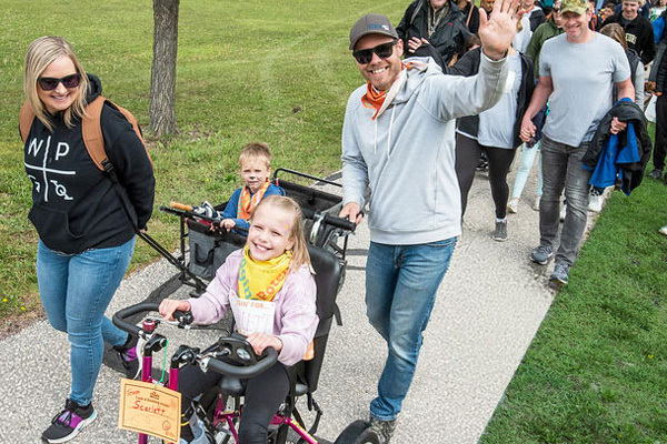 families outside walking Cruisin to change lives event