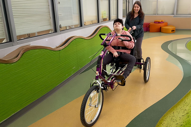 Zoey riding bicycle indoors